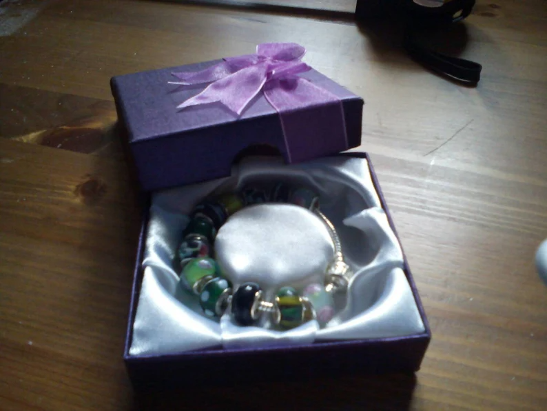 Stunning floral summer hedgerow charm bracelet. Snake Chain with snap closure. Gift boxed.