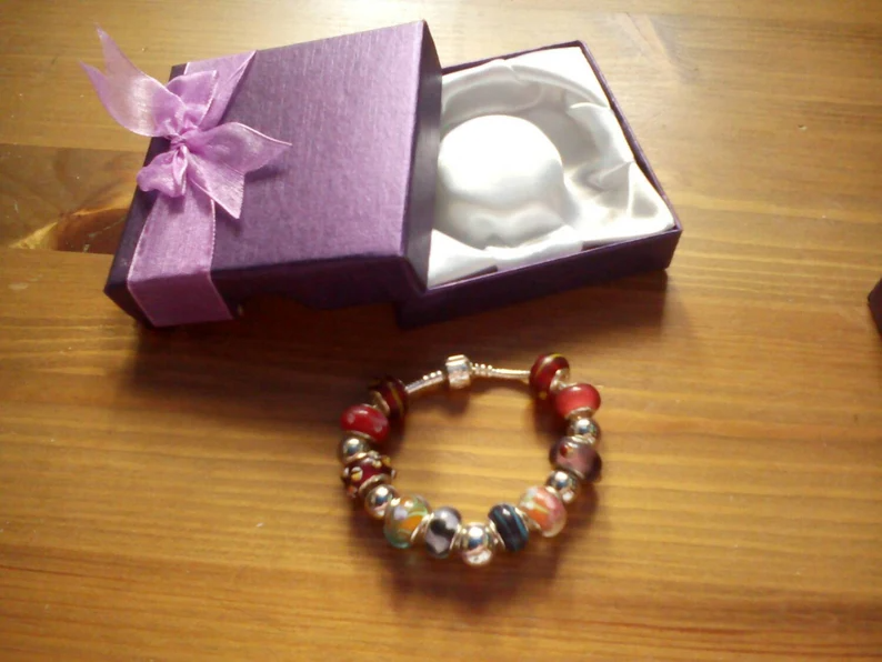 Stunning Warm Reds Summer charm bracelet. Snake Chain with snap closure. Gift boxed.