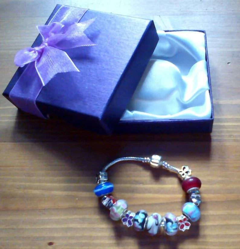 Stunning floral summer charm bracelet with butterflies. Snake Chain with snap closure. Gift boxed.