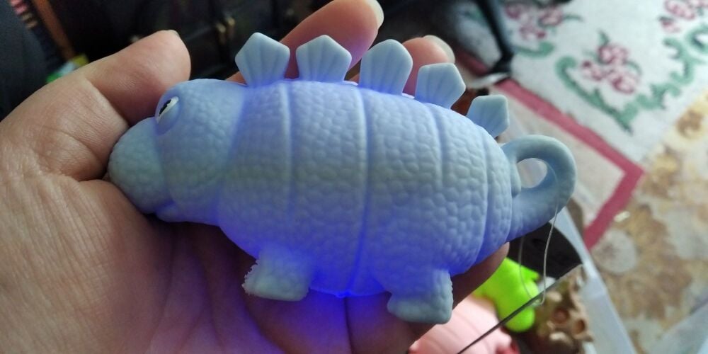 Pale Blue Light Up Puffy Dinosaur with colourful LED ball inside - Hoot