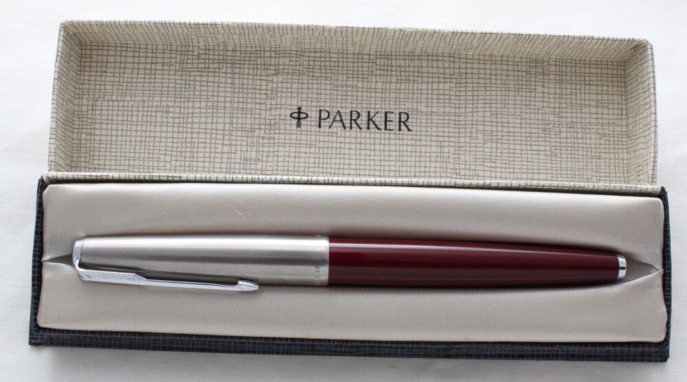 5337 Parker 65 in Burgundy with a Lustraloy cap. Fine side of Medium FIVE STAR Nib. Mint and Boxed.