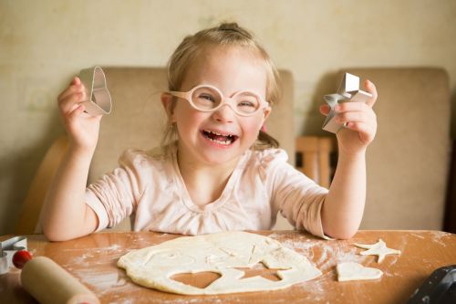 child playiing with dough and cutters