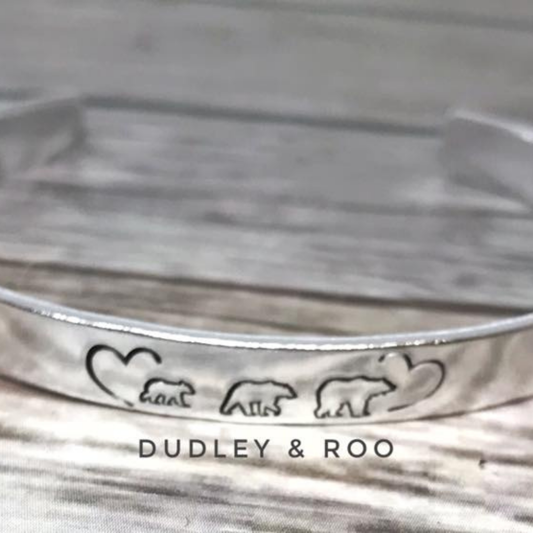 silver coloured cuff bangle hand stamped with bears