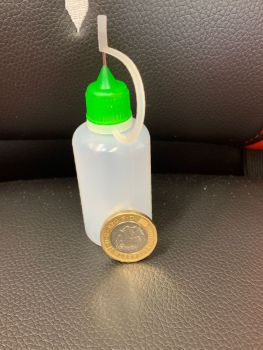 Empty plastic bottle with needle tip for ease of oil application