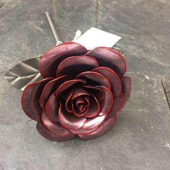 Steel metal rose with a hint of red