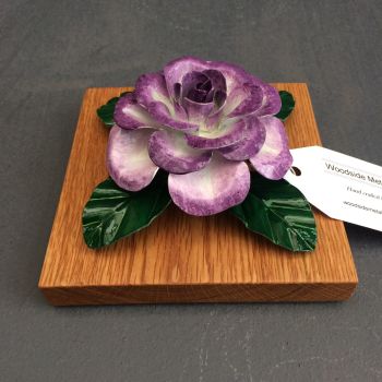 Purple and white steel rose on an oak base