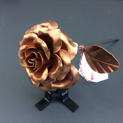 Elegant copper rose with leaves and a display stand