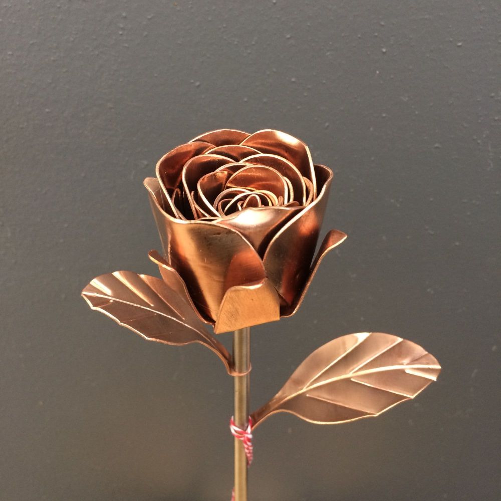 Copper metal rose on a steel stem with copper leaves