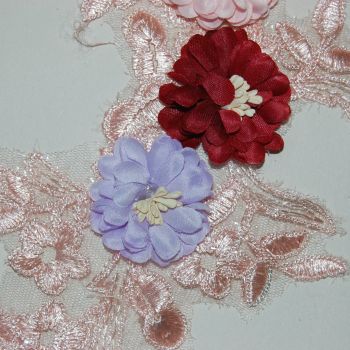 SEW ON EMBELLISHMENT WITH 3 FLOWERS, ON A VERY FINE PEACH NET.