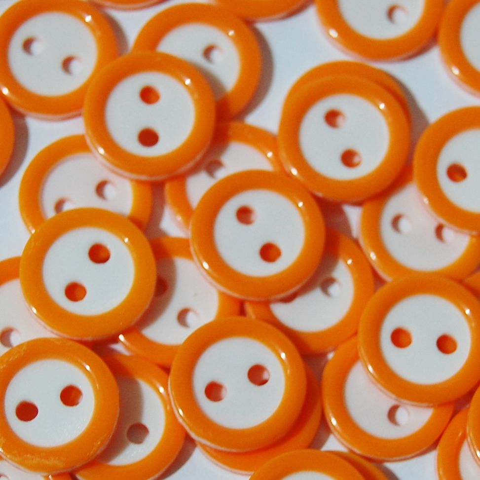 PACK OF 15 2 HOLE 10MM BUTTONS,  IN ORANGE AND WHITE.