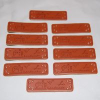 PACK OF 10 LEATHER LOOK TAGS. HANDMADE WITH A SEWING MACHINE, SCISSORS AND NEEDLE.