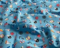 COTTON MIX, SEA THEMED FABRIC PRINT ON A PALE BLUE BACKGROUND.