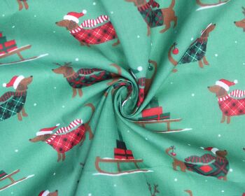 80% Cotton, 20% poly Christmas sausage dogs on forest green.