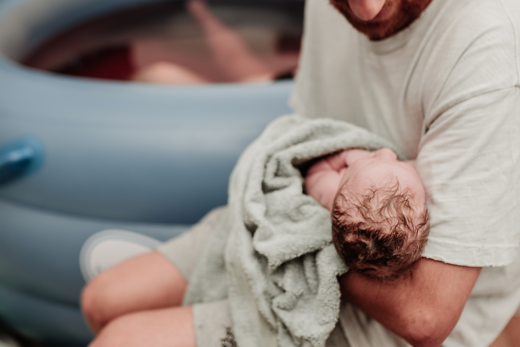 Father holding newborn