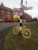yellow-tour-bike-by-village-sign