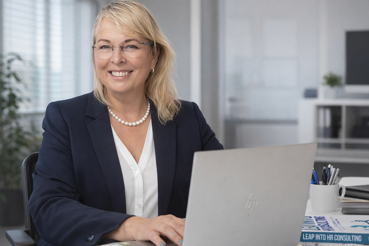 Picture of Sarah on teh screen of a laptop with a woman watching a webinar