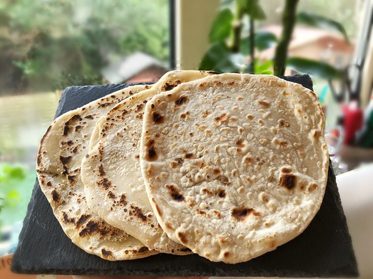 3 chapatis on a slate mat