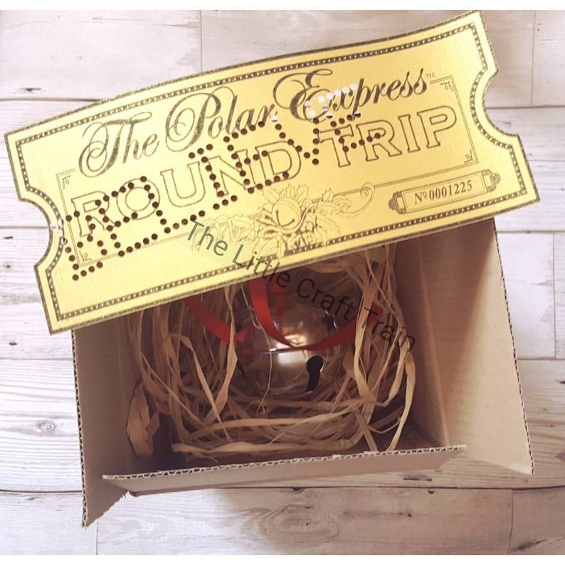 The Polar express box including themed golden ticket with 'believe ' a large silver bell (with red ribbon) all in a bed of raffia