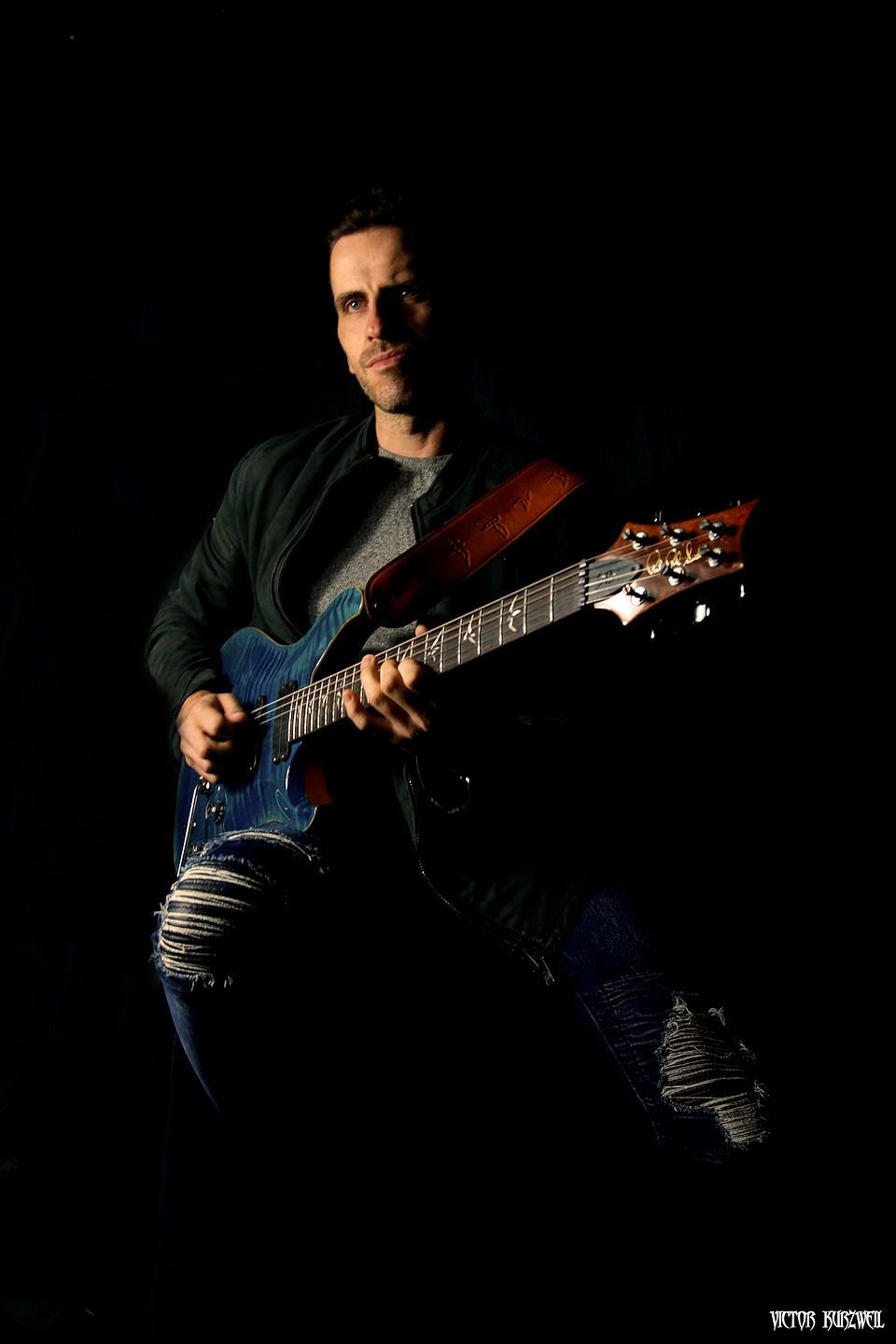 James Roberts with Guitar on black