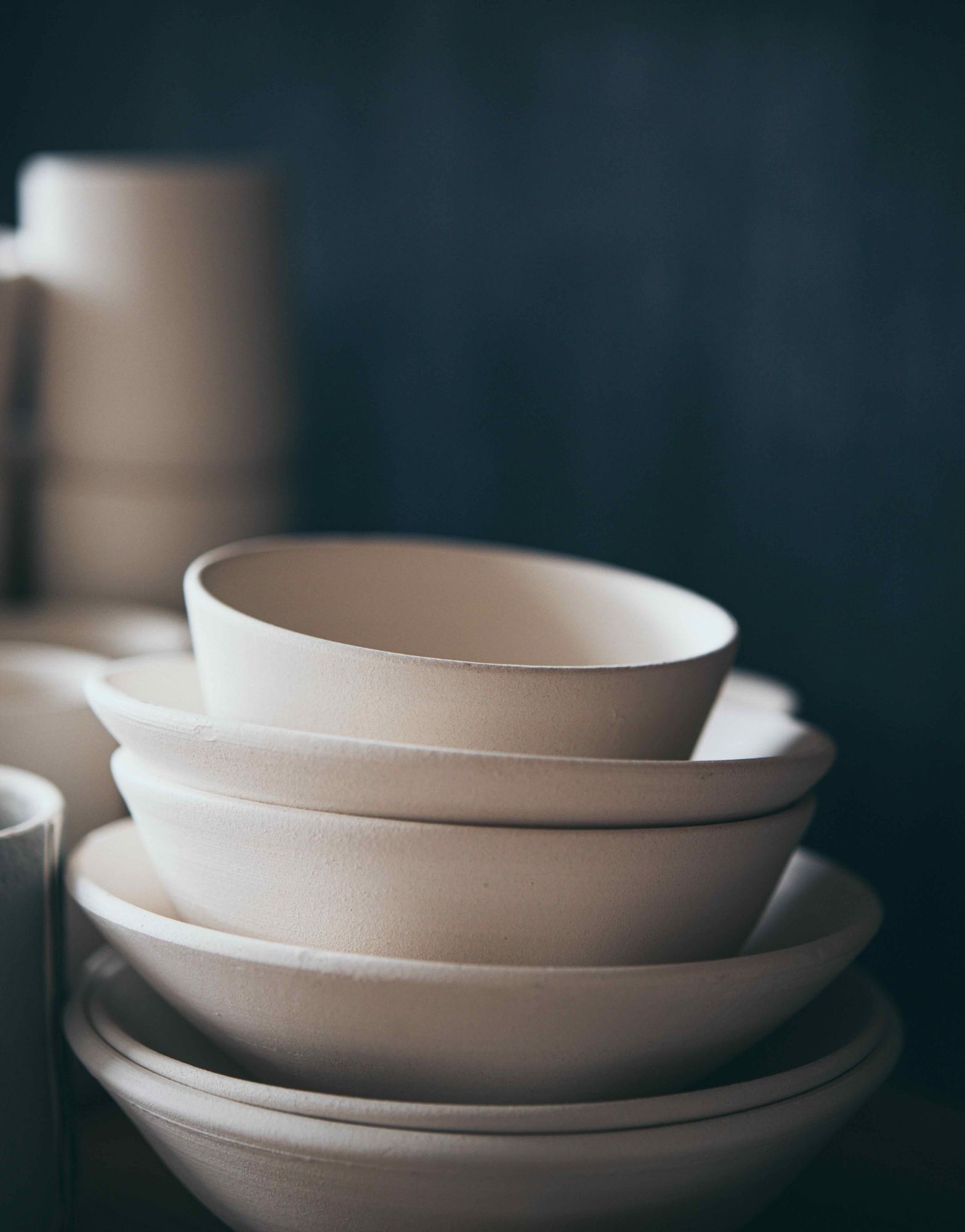 A stack of ceramic bowls fired ready to glaze 