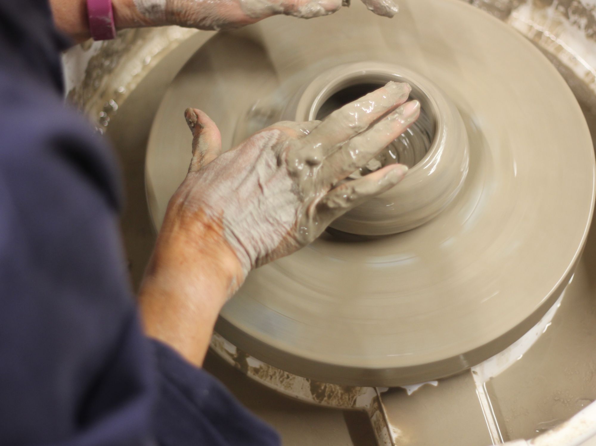 Potters wheel throwing opening clay