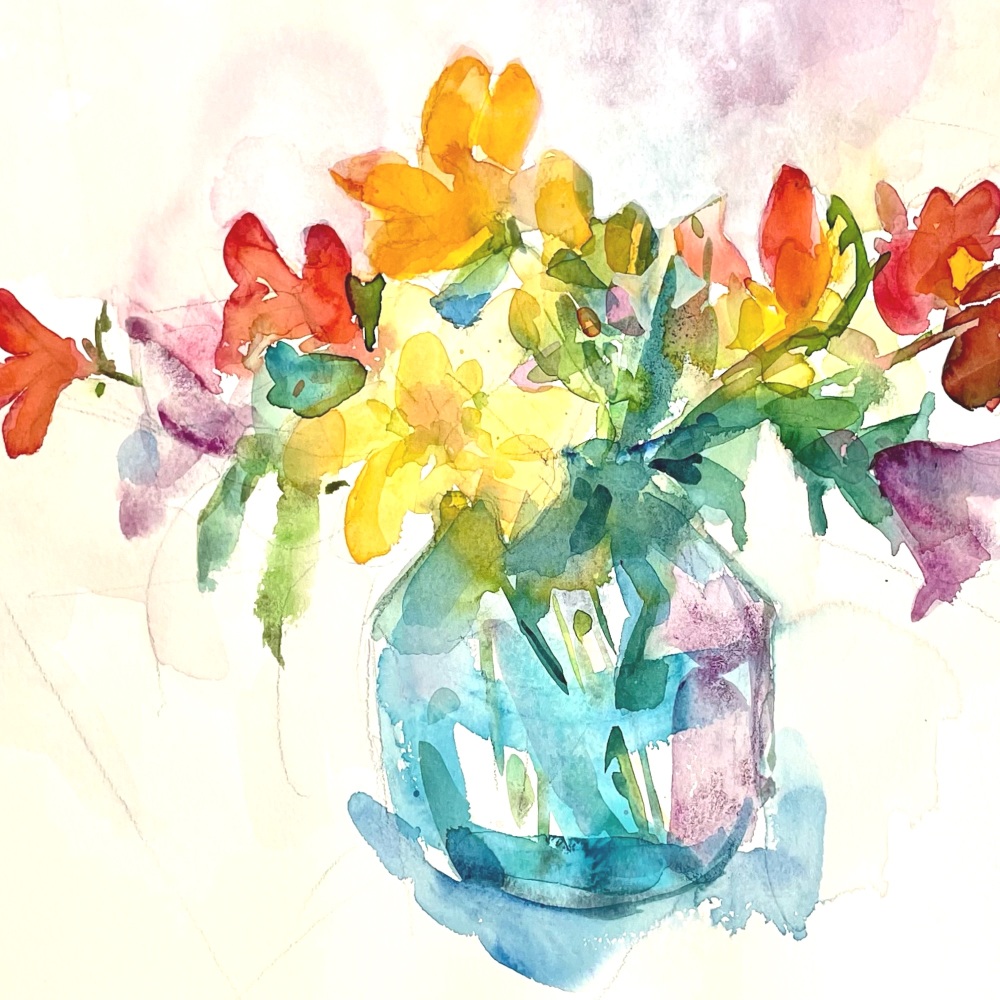 Freesias in a glass vase