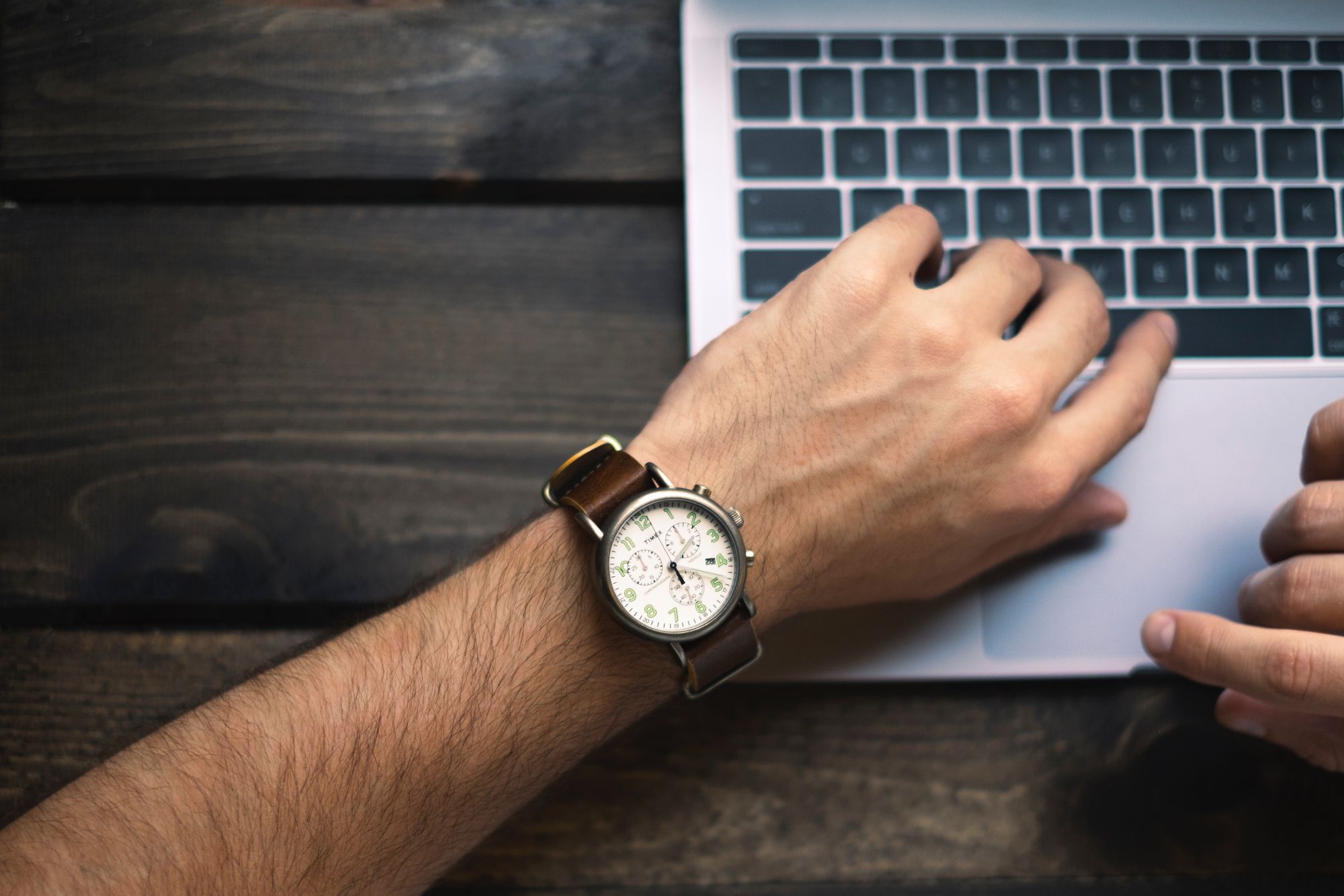 A close up of a watch on a man's wrist