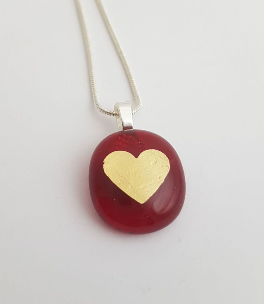 Small transparent red pendant with gold mica heart