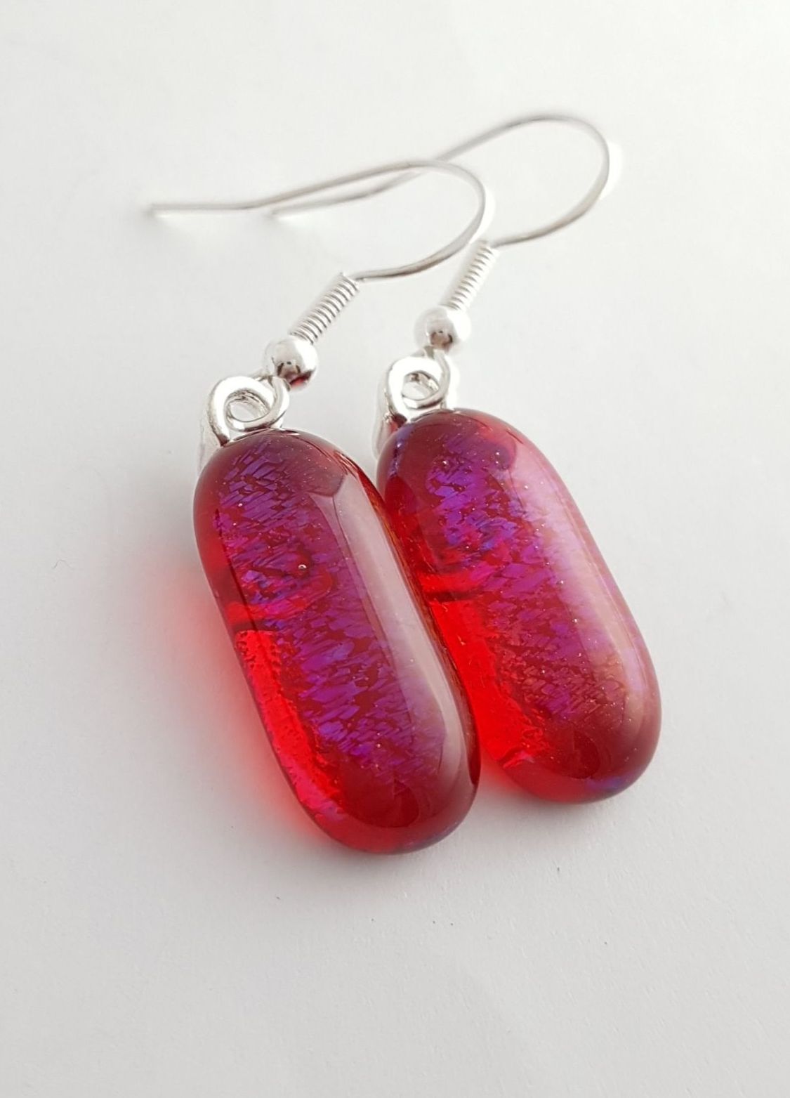 Iridescent red glass earrings with blue shimmer inside