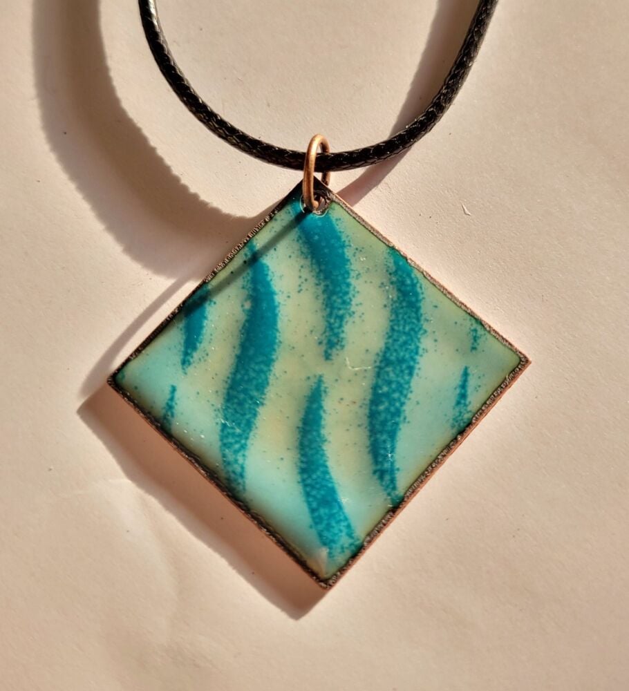 Light blue with a teal blue wavy pattern necklace. Reversible