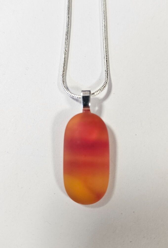 Frosted "sea glass" effect orange swirly pendant