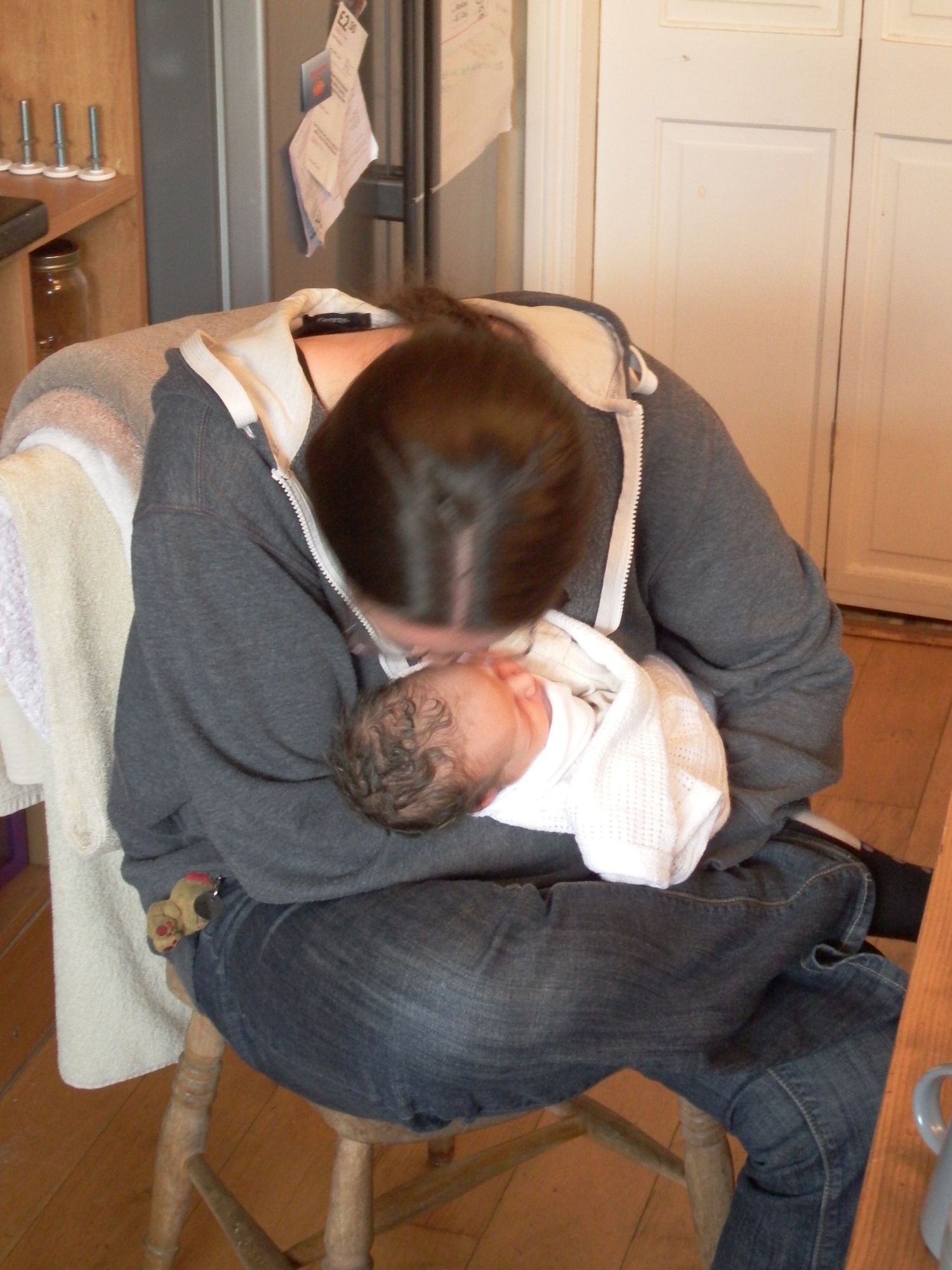 Caz smelling the top of a baby's head