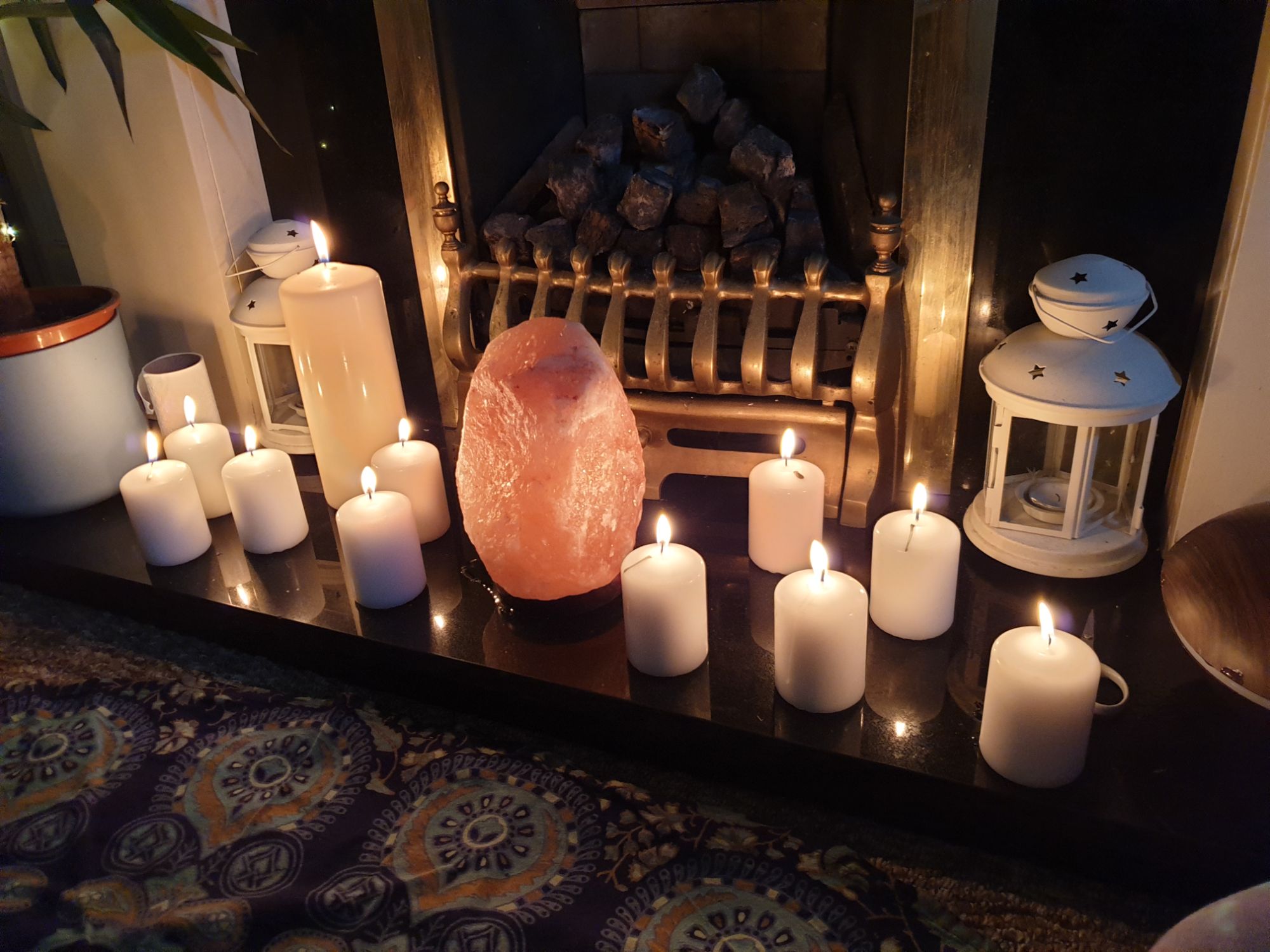 11 candles displayed on a hearth - one large one for the mother and 10 small ones for her guests.