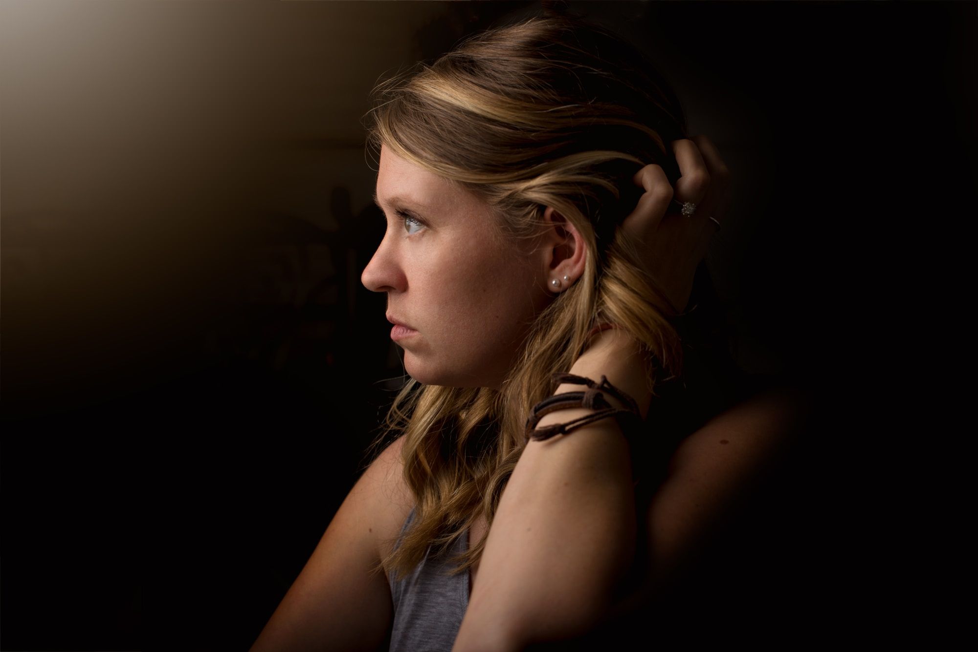 Image of a woman look offscreen, a thoughtful expression on her face.