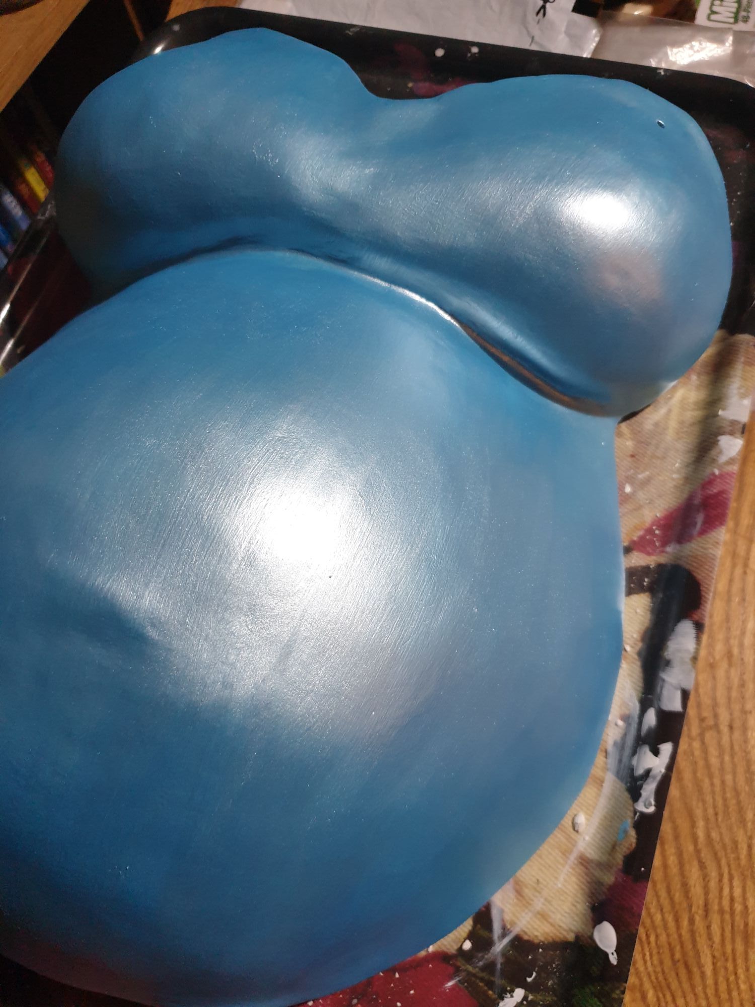 The cast with its first layer of background paint on it. The paint is a shimmery sky blue colour.