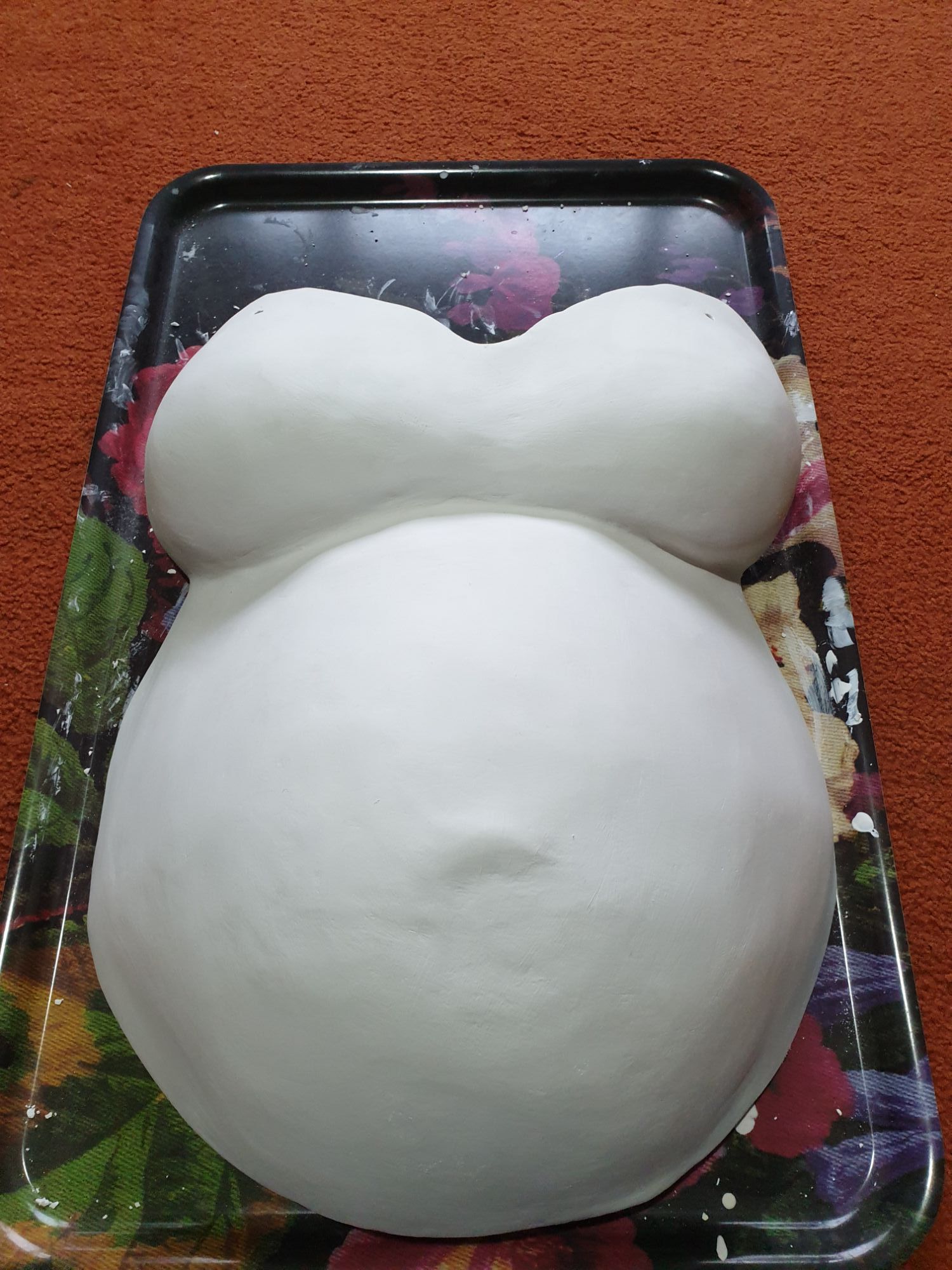 The cast with multiple layers of smoothing plaster on it.