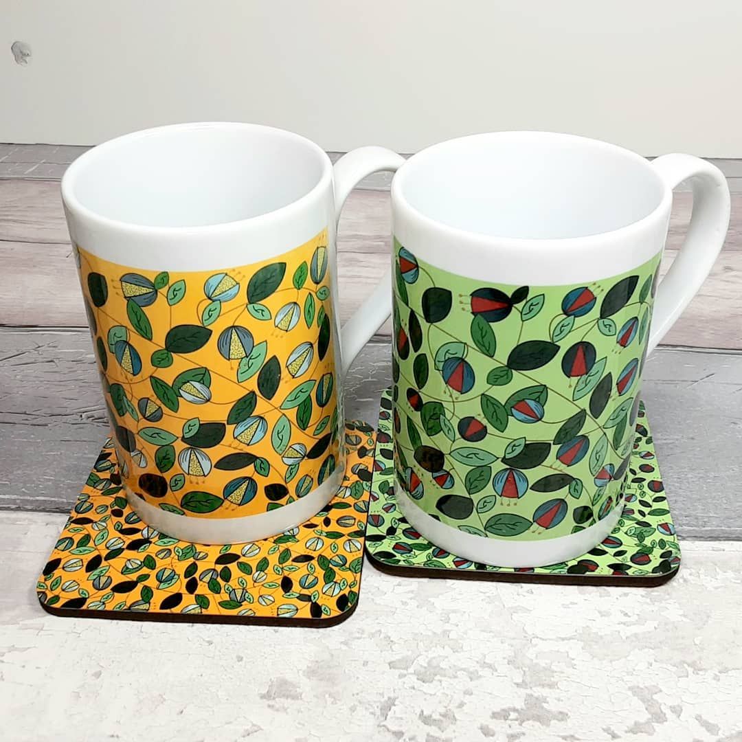 Slim porcelain mugs in yellow and green with botanical pattern
