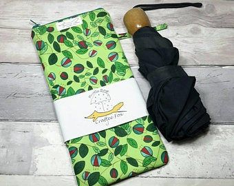 Umbrella bag for a wet umbrella. Zip waterproof bag in green with floral pattern