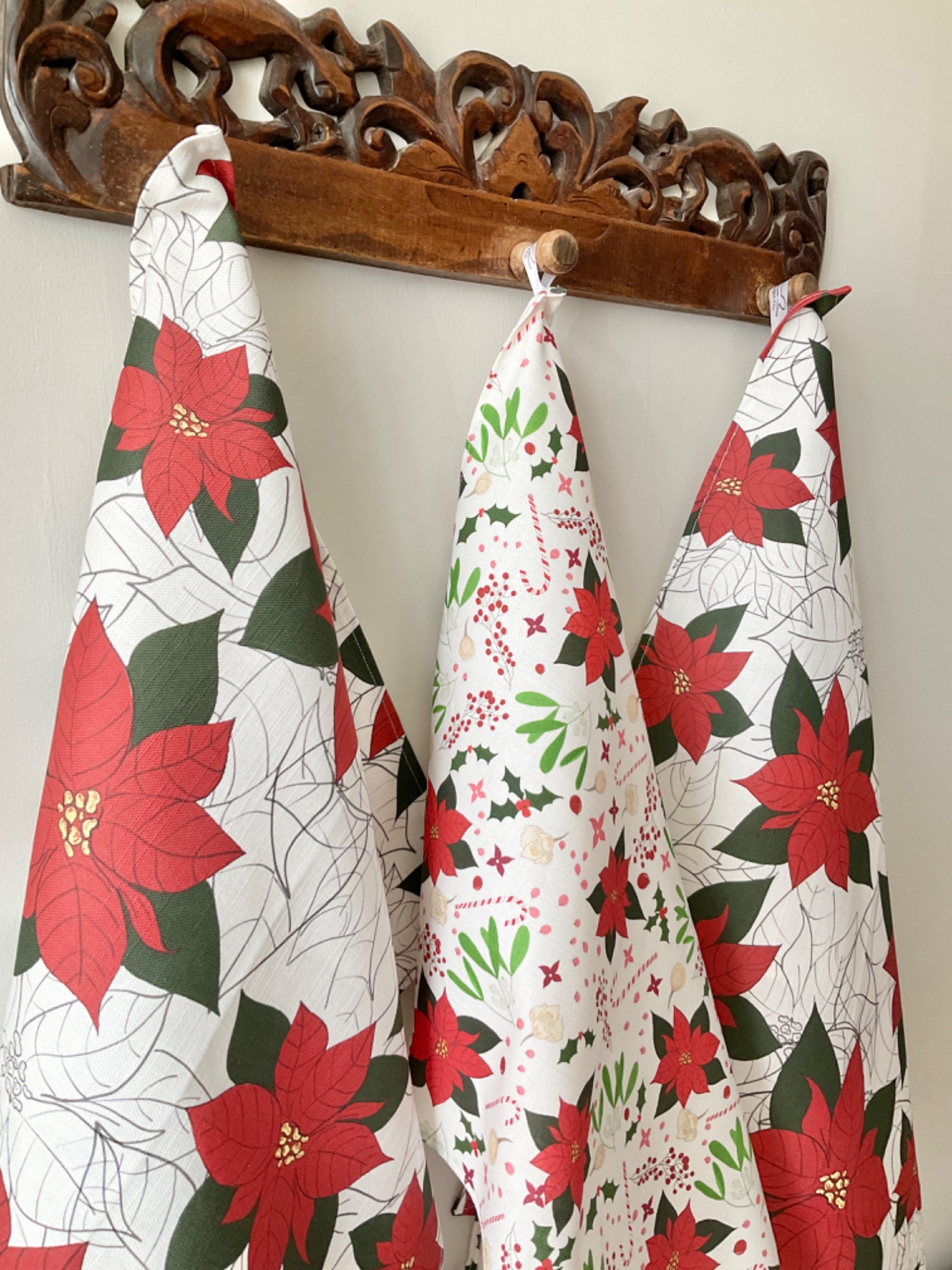 Christmas tea towels with poinsettia, holly, mistletoe and candy canes