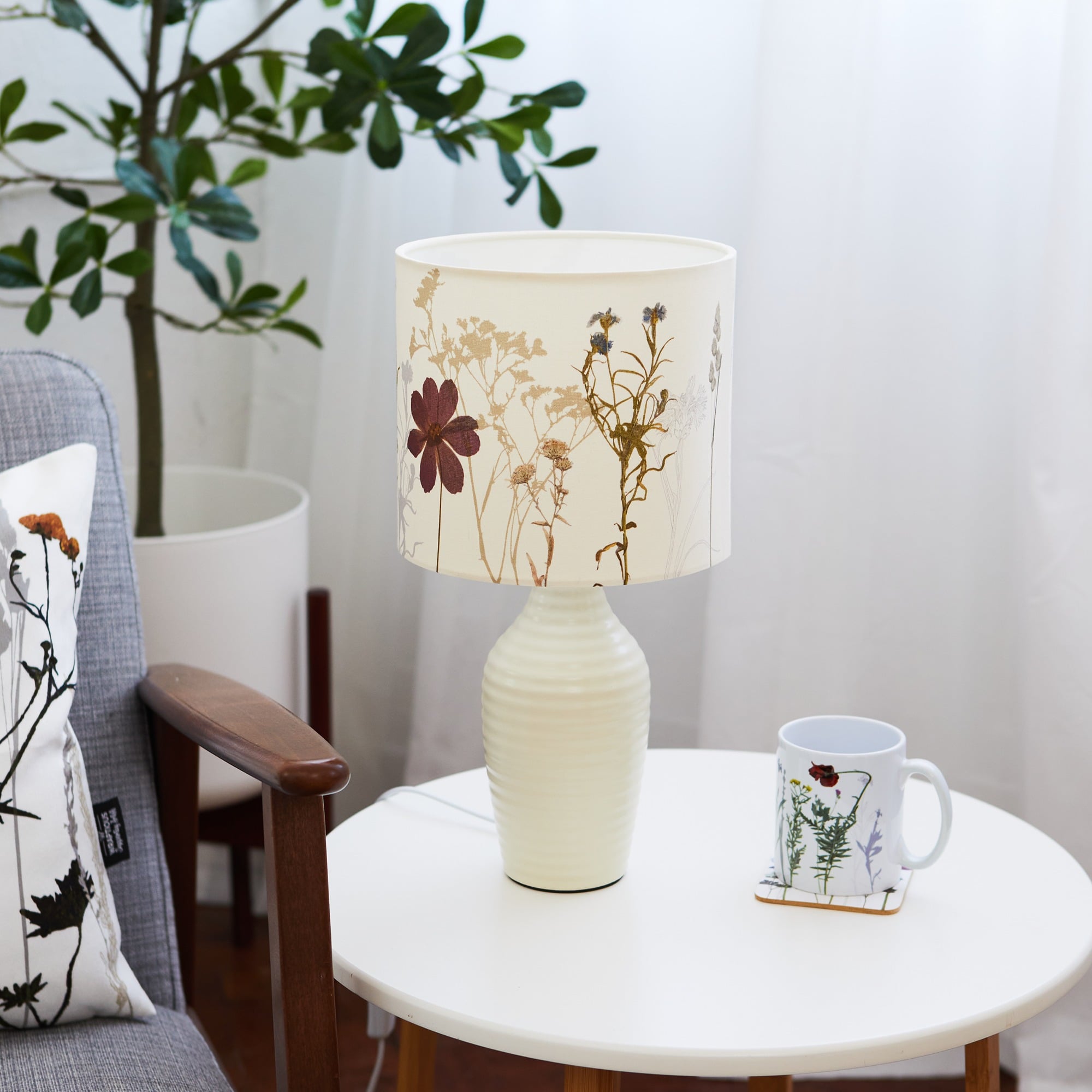 Handmade cream fabric lampshade with delicate wildflower patterns, nature-inspired home lighting accessory.