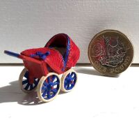 Red Pram with Cover and Baby