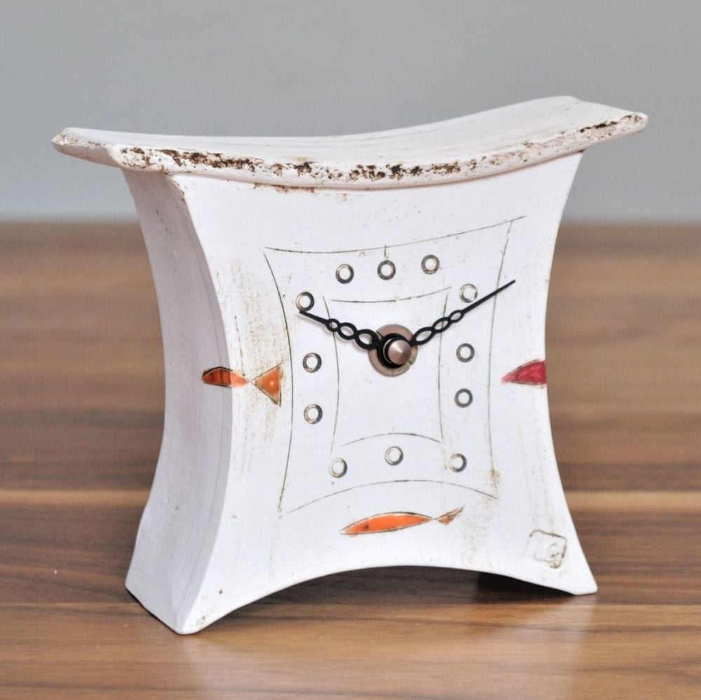 Handmade ceramic mantel clock with red and orange fish design.
