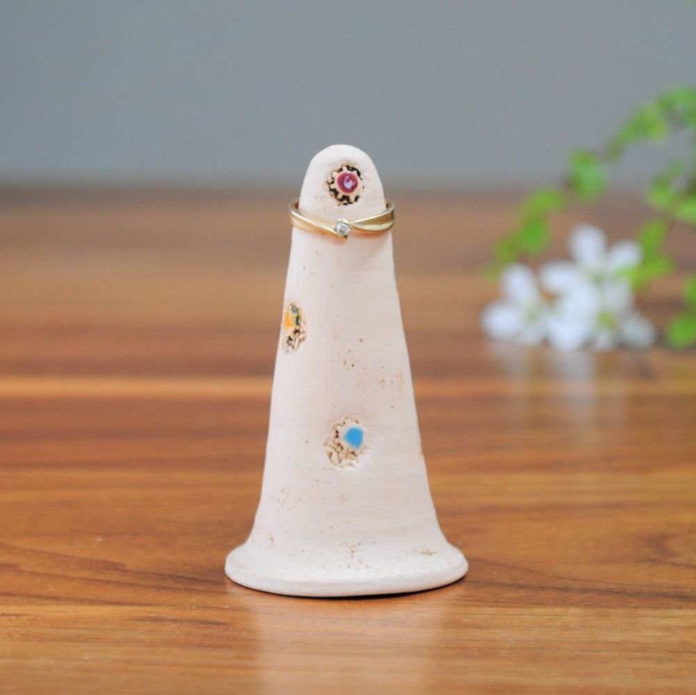 Handmade ceramic ring holder made from white clay, decorated with flowers.