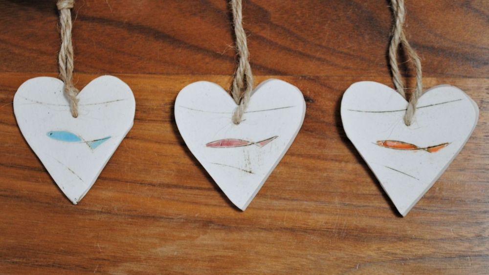 Set of 3 hanging little hearts handmade from a white clay and decorated wit