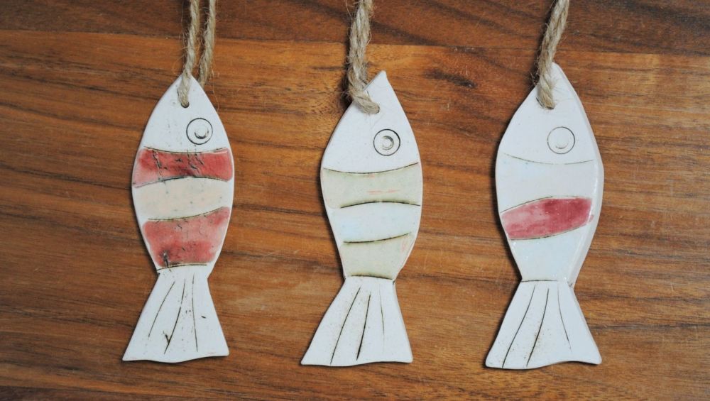 Set of 3 hanging little fish handmade from a white clay and decorated with 