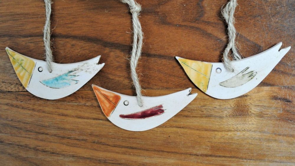 Set of 3 hanging little birds handmade from a white clay and decorated with