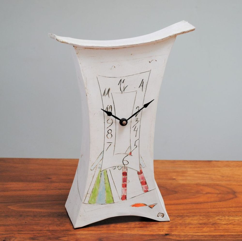 Handmade, large mantel clock from white clay with beach huts & fish detail.
