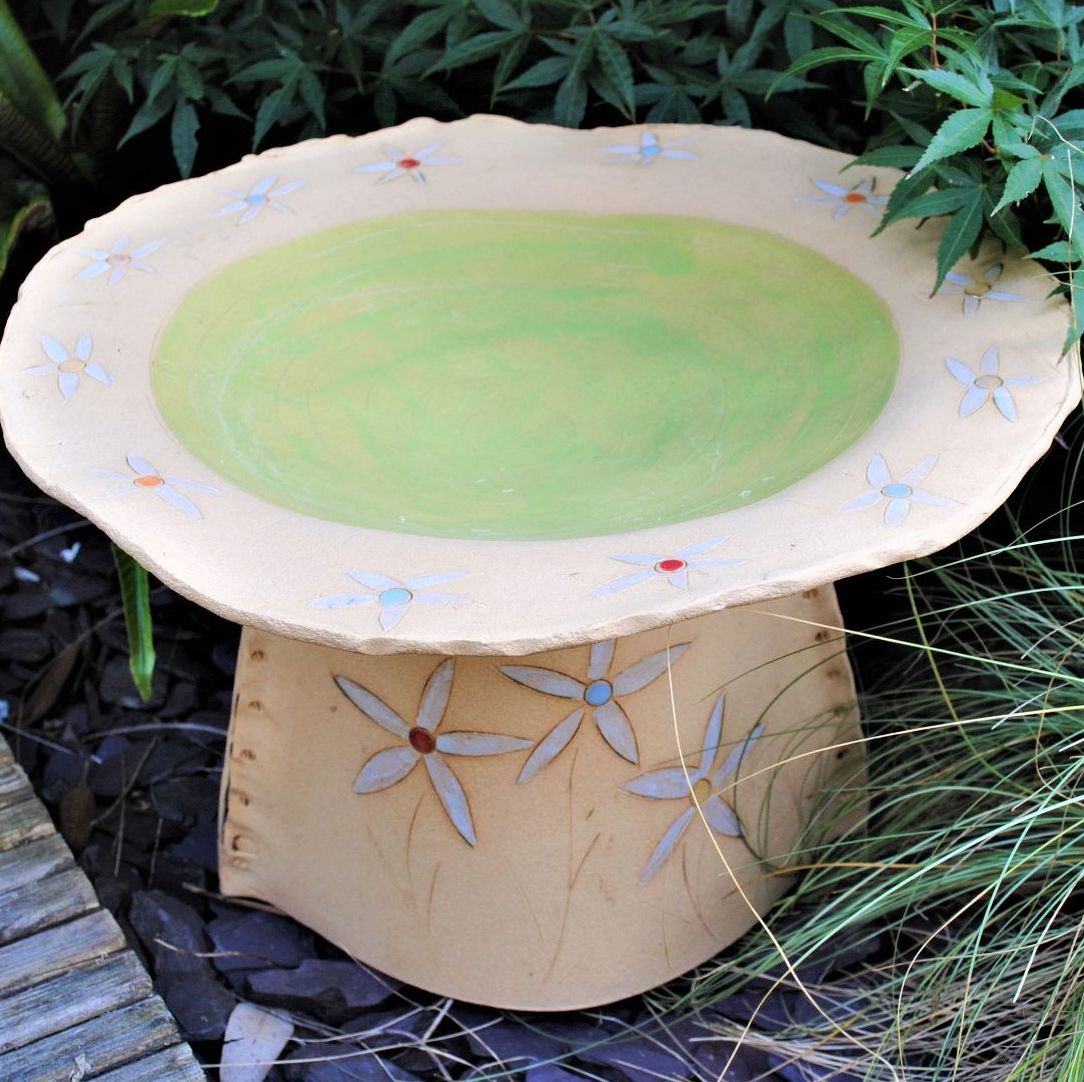Medium size bird bath with flowers design and green glaze.