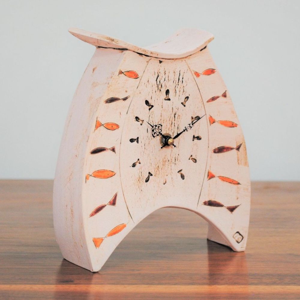 Medium ceramic mantel clock with fish design.