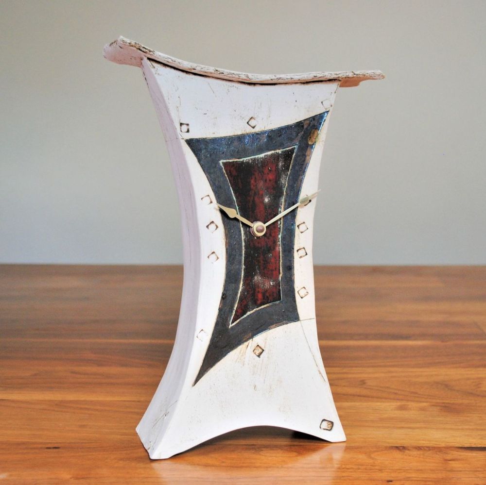 Large mantel contemporary clock with metalic and deep red glazes. 